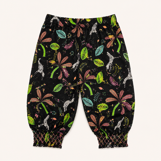 Pantalon sarouel noir fluide à imprimé jungle et bas smoqués – Orchestra