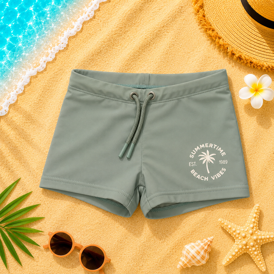 Maillot de bain type boxer garçon vert pastel imprimé plage exotique